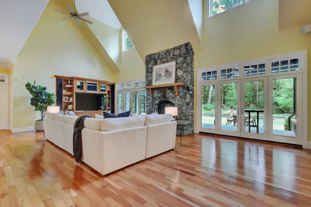 a living room with furniture and large windows