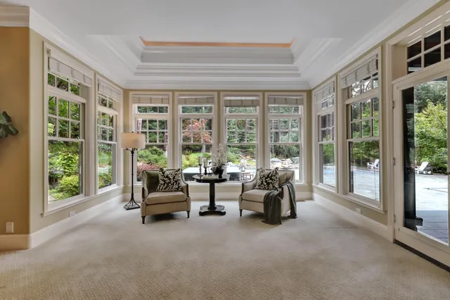 an aerial view of a house with swimming pool and porch with furniture