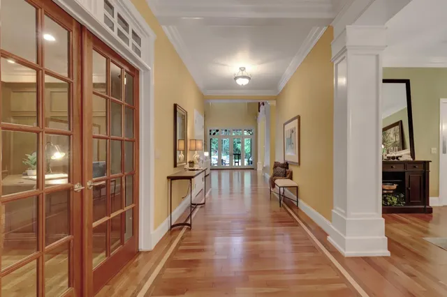 a view of a dining room with furniture and a chandelier