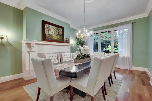 a living room with furniture a fireplace and a large window