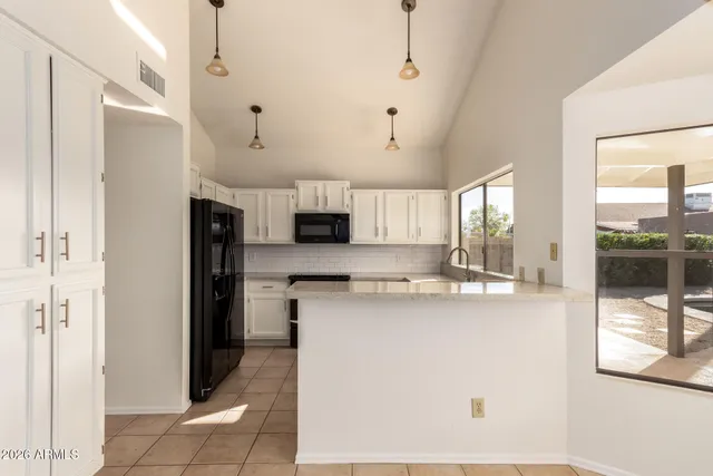 a kitchen with granite countertop a sink and a window