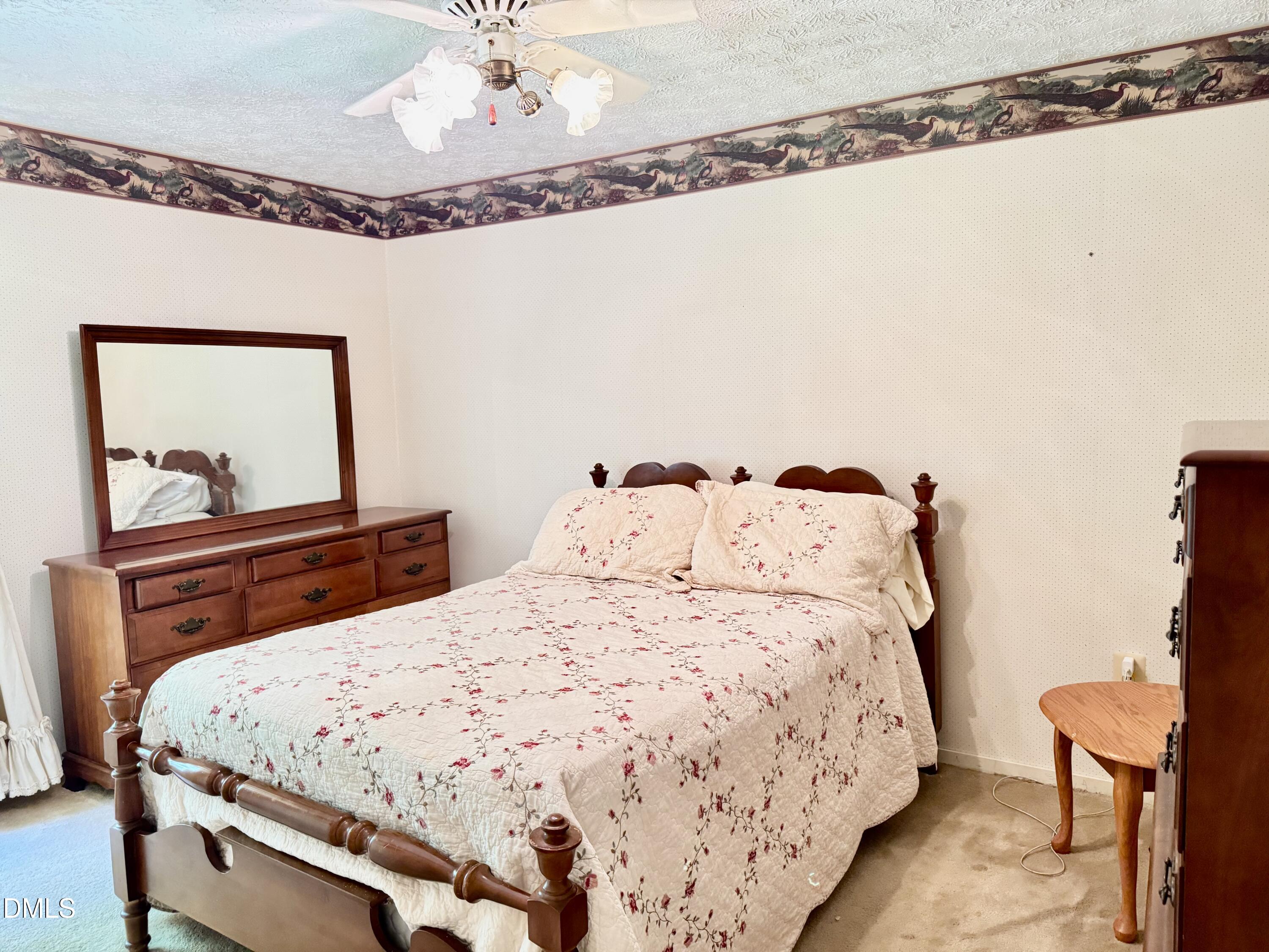 84 Wintergreen Road Henderson, NC 27537 - Photo 29 of 49 a bedroom with a bed and a mirror on the dresser