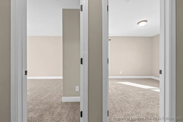 an empty room with ceiling fan and window