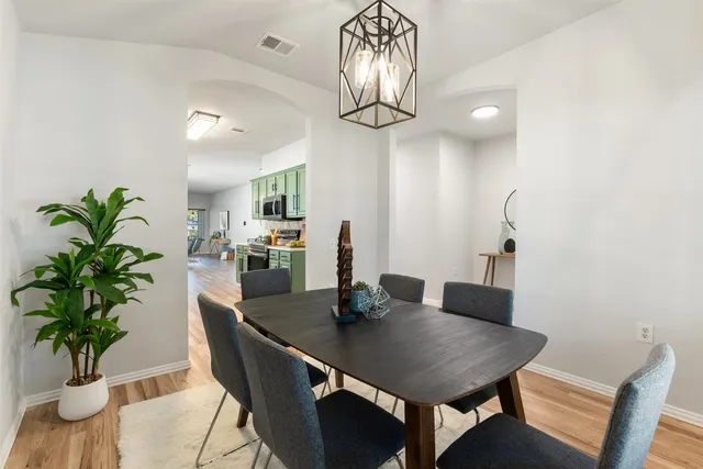 a kitchen with stainless steel appliances a sink dishwasher stove refrigerator and cabinets