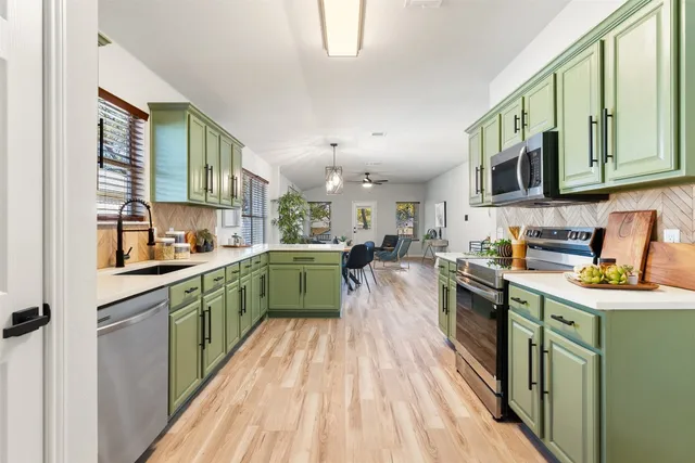 a kitchen with lots of counter top space and wooden floor