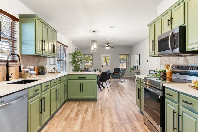 a kitchen with a sink and cabinets