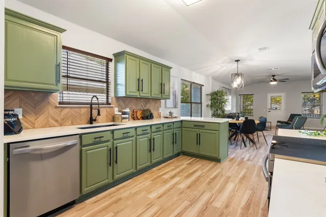 a kitchen with a refrigerator and a sink