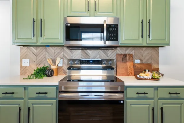 a living room with furniture a chandelier and a wooden floor