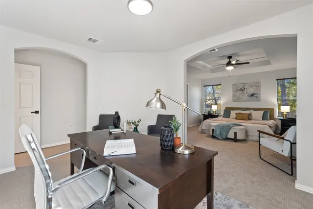 a bedroom with a bed and a chandelier