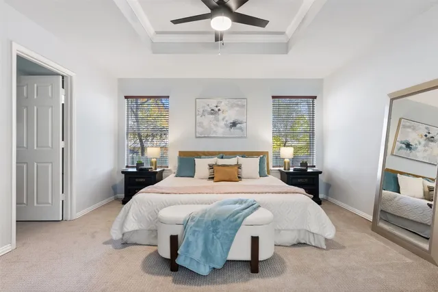 a spacious bedroom with a bed and wooden floor