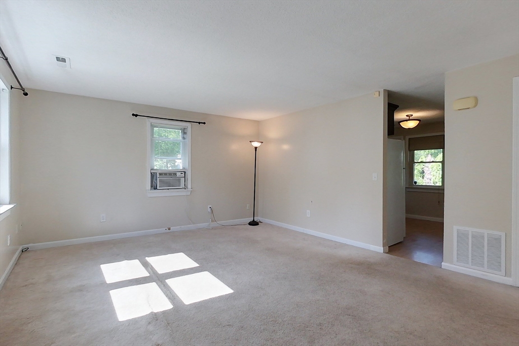 103 Main Street, Unit 10 Pepperell, MA 01463 - Photo 7 of 22 an empty room with windows and closet