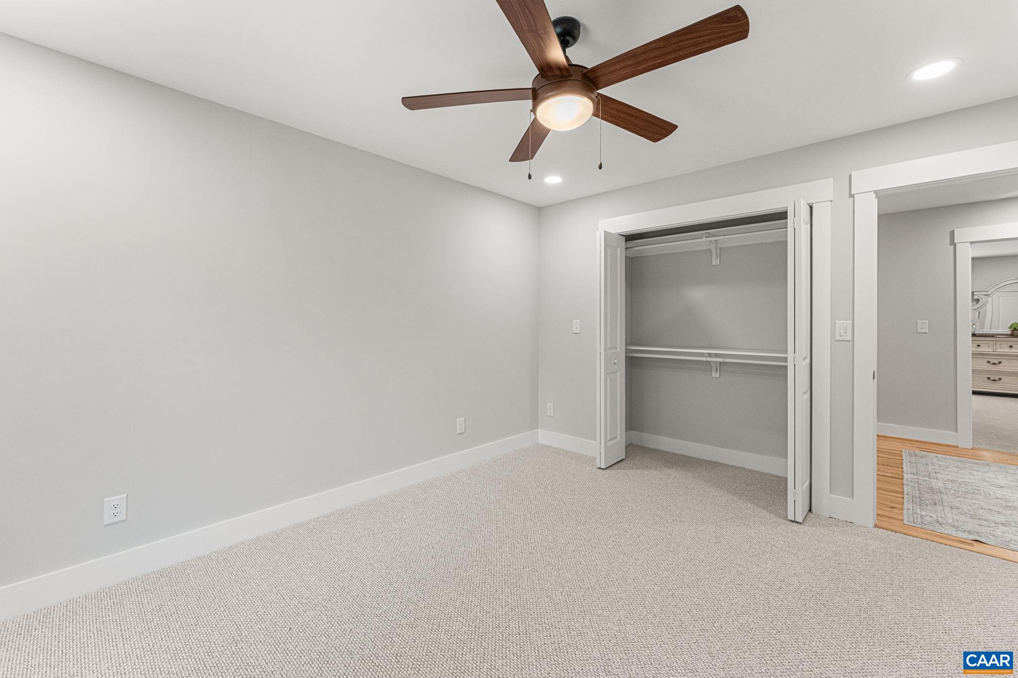 230 Fox Hollow Road Ruckersville, VA 22968 - Photo 29 of 42 an empty room with ceiling fan and windows