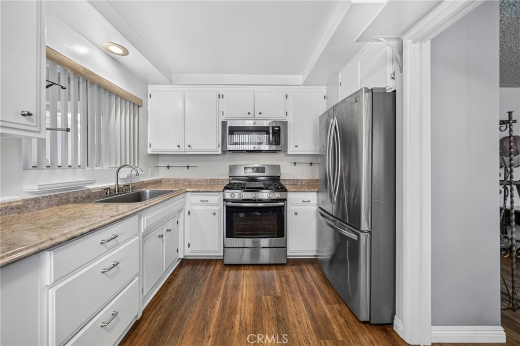 29078 Bradley Road Menifee, CA 92586 - Photo 16 of 42 a kitchen with a refrigerator stove and sink