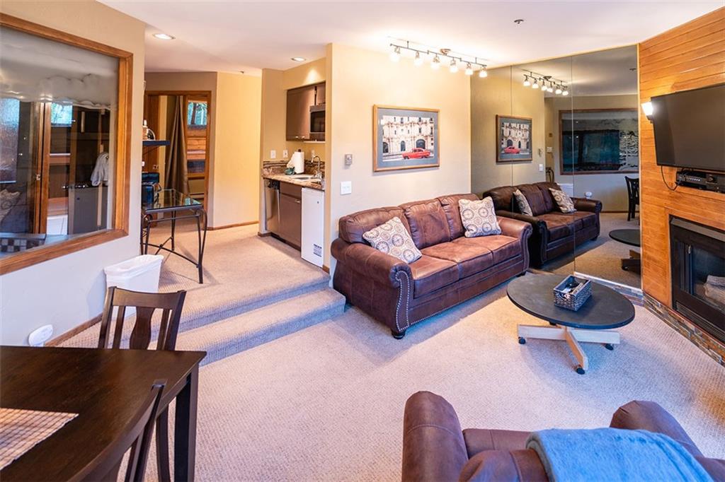 24 River Run Road, Unit 2906 Keystone, CO 80435 - Photo 2 of 15 a living room with furniture and a flat screen tv
