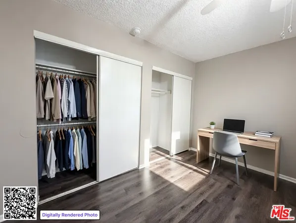 a view of a workspace with furniture and closet