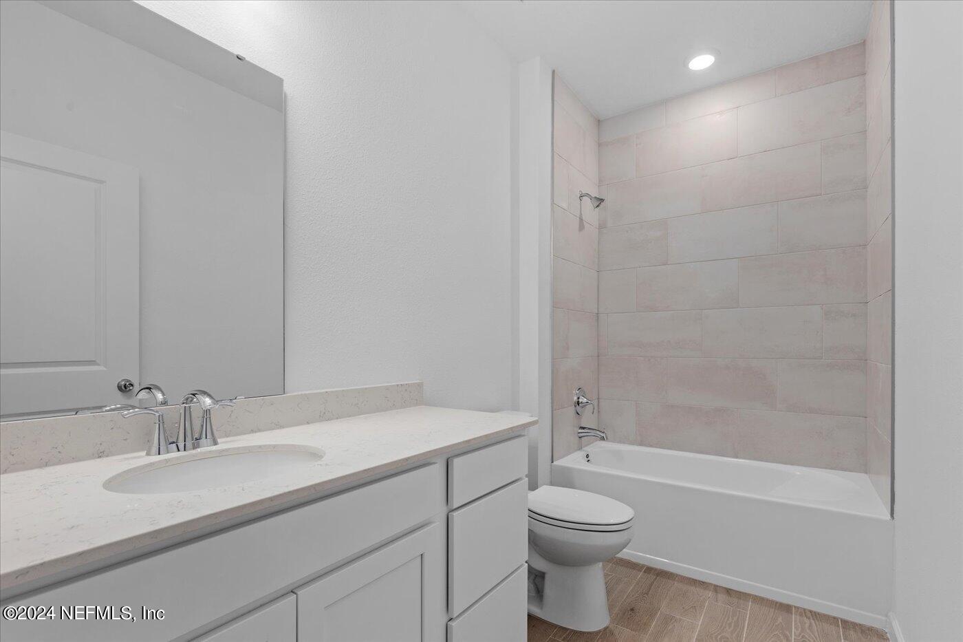 214 Blue Cypress Trail St. Augustine, FL 32084 - Photo 17 of 28 a bathroom with a sink a toilet and shower