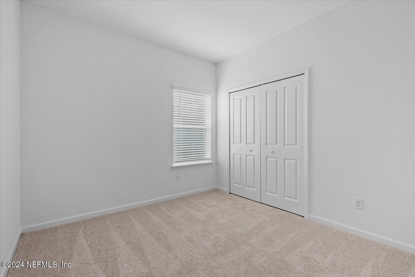 214 Blue Cypress Trail St. Augustine, FL 32084 - Photo 19 of 28 a view of an empty room with a window