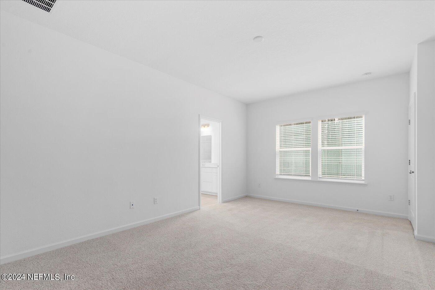 214 Blue Cypress Trail St. Augustine, FL 32084 - Photo 21 of 28 an empty room with a window
