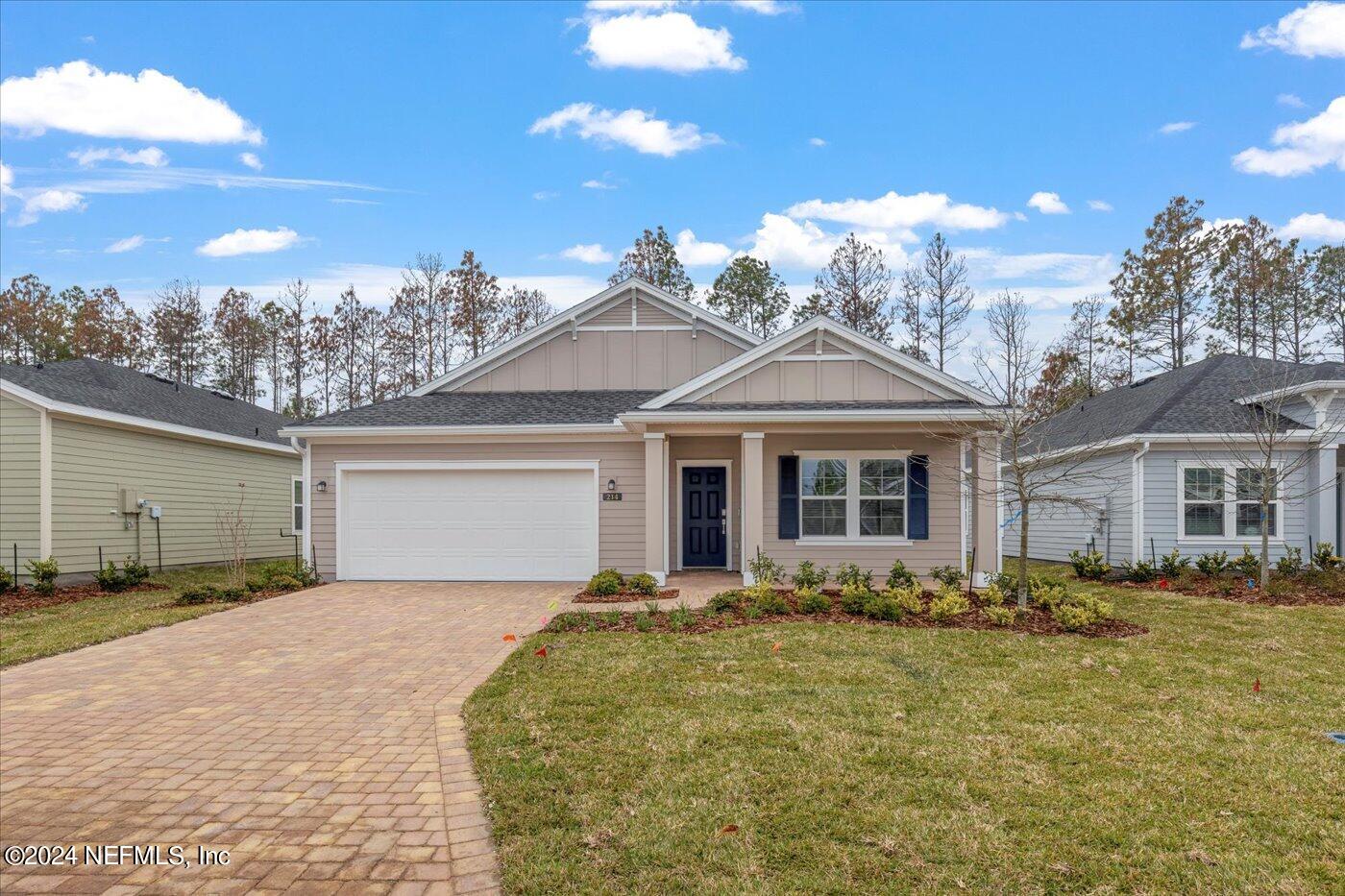 214 Blue Cypress Trail St. Augustine, FL 32084 - Photo 4 of 28 a front view of a house with a garden