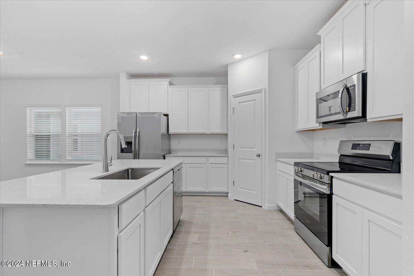 214 Blue Cypress Trail St. Augustine, FL 32084 - Photo 10 of 28 a kitchen with stainless steel appliances granite countertop a sink stove oven and refrigerator