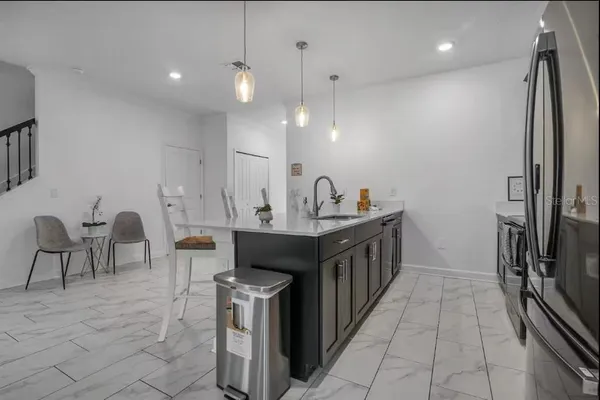 a kitchen with stainless steel appliances a sink and a refrigerator