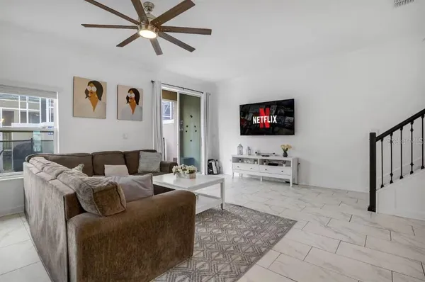 a living room with furniture and white walls