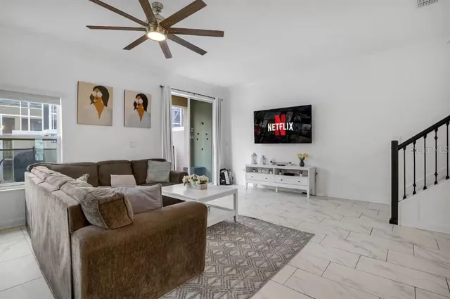 a living room with furniture and white walls