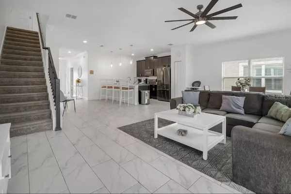 a living room with furniture and a wooden floor