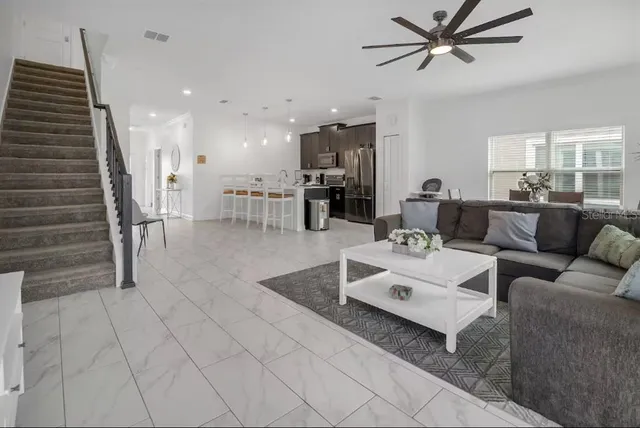 a living room with furniture and a wooden floor