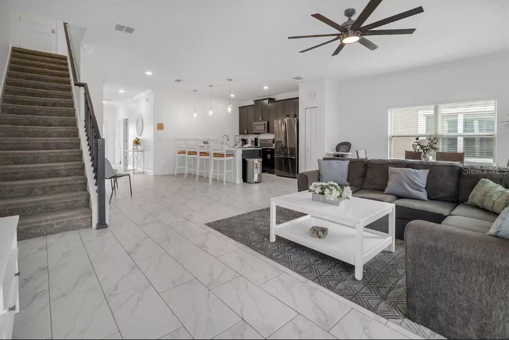 978 Splash Shot Place Davenport, FL 33896 - Photo 8 of 20 a living room with furniture and a wooden floor