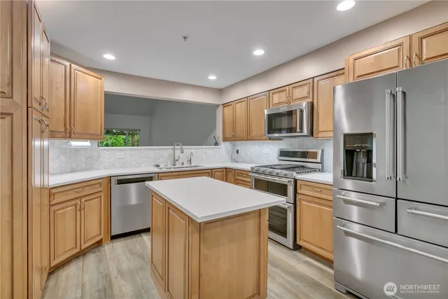 a kitchen with a sink stove and refrigerator