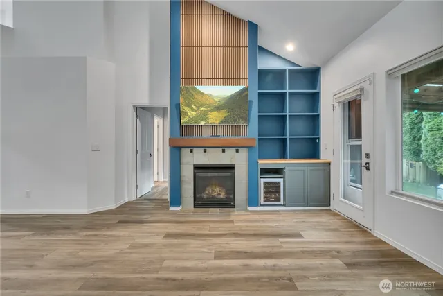 a view of an empty room with a fireplace and a window