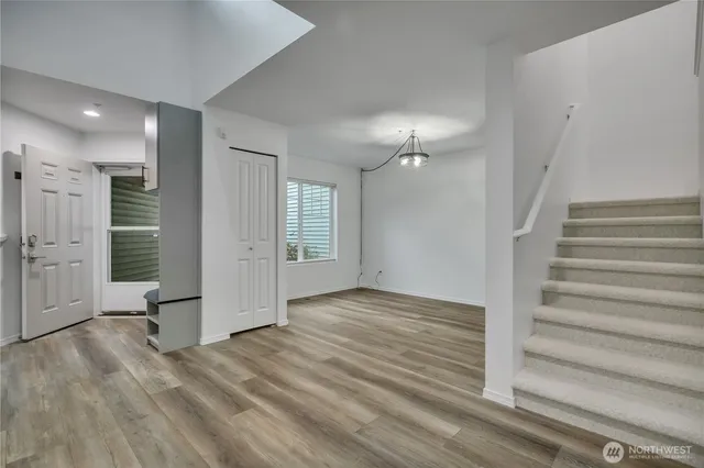 a view of entryway with wooden floor and stairs