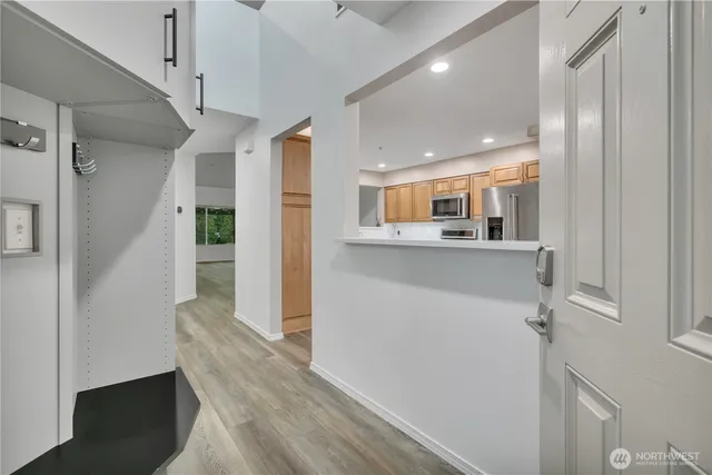 a view of a kitchen and an empty room