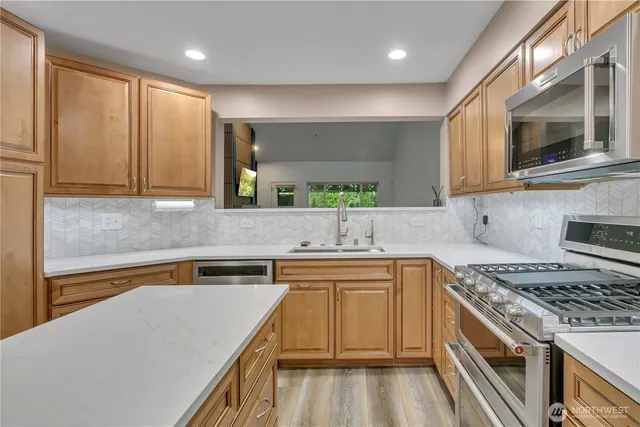 a kitchen with a sink stove and microwave