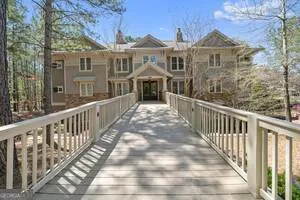 a view of a brick house with wooden fence