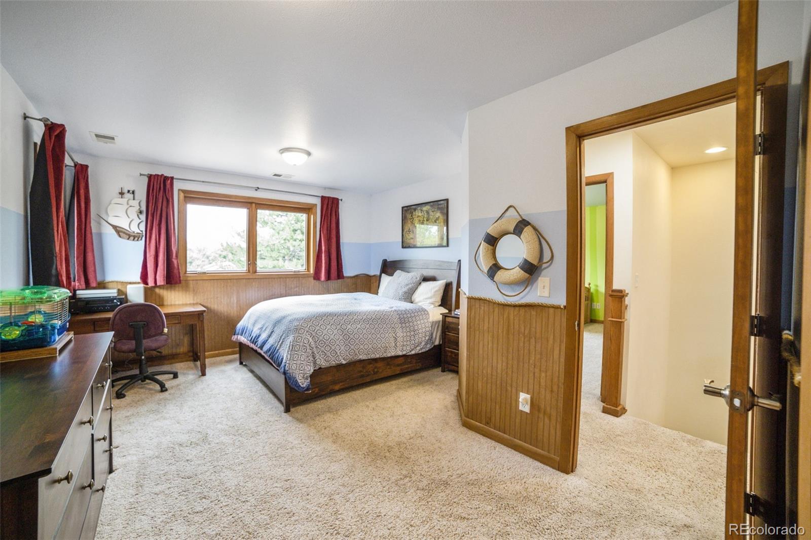 4780 McKinley Drive Boulder, CO 80303 - Photo 18 of 37 a bedroom with a bed and a dresser next to a window