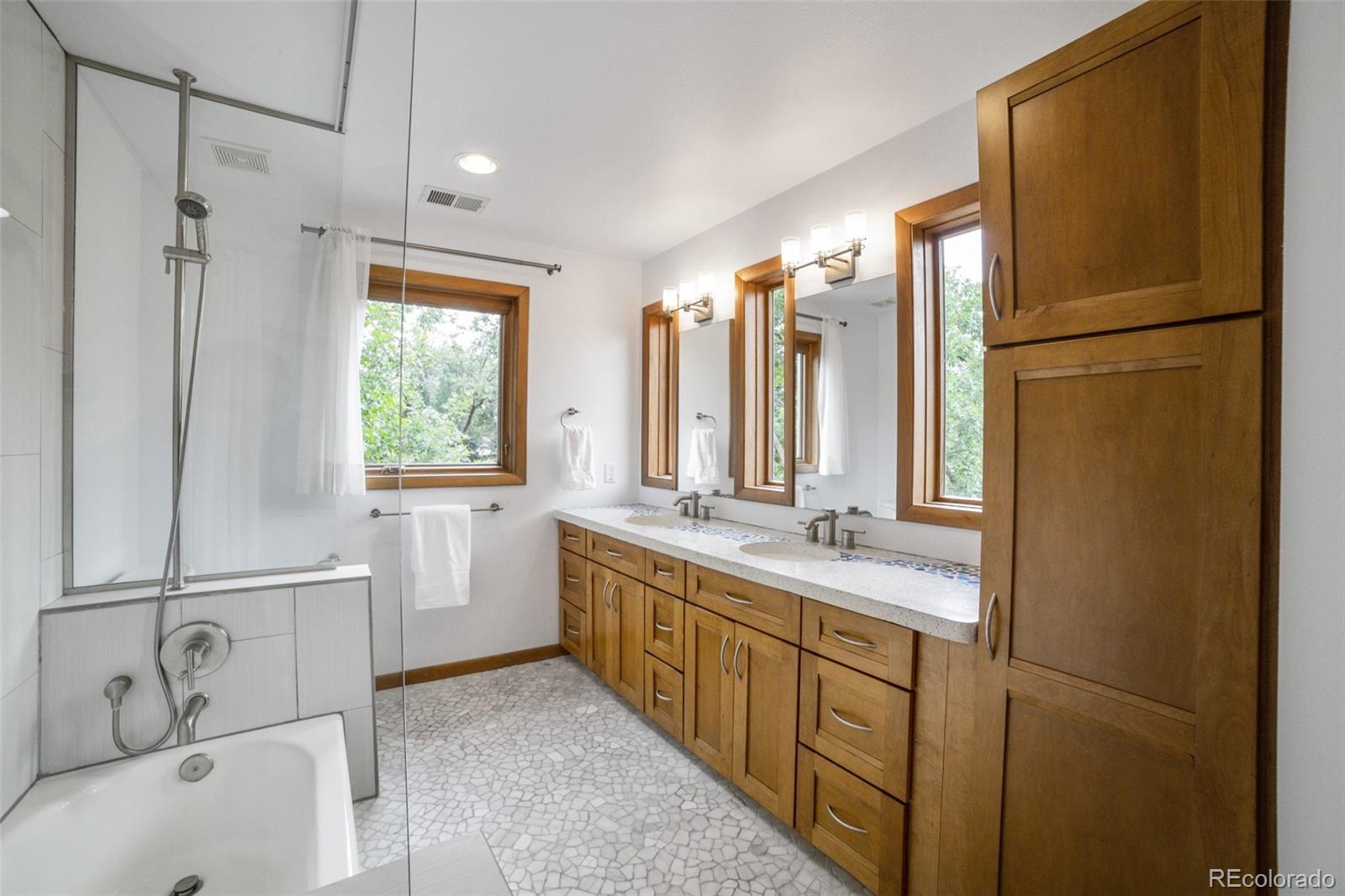 4780 McKinley Drive Boulder, CO 80303 - Photo 20 of 37 a bathroom with a double vanity sink a mirror and a bathtub