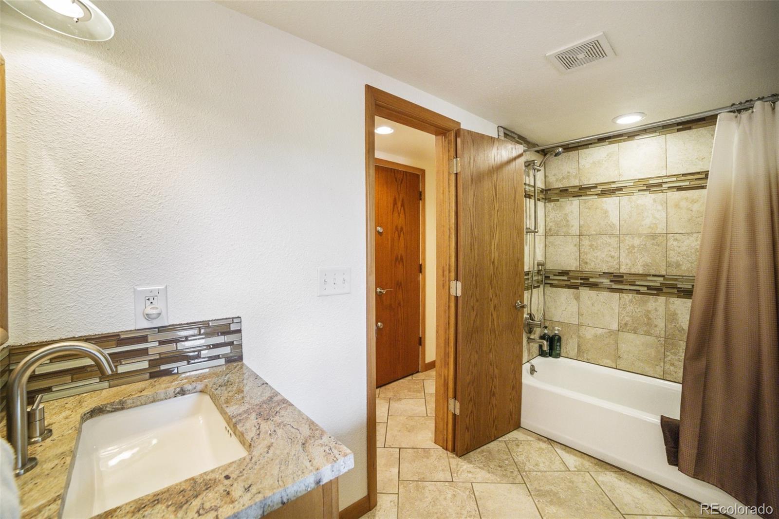 4780 McKinley Drive Boulder, CO 80303 - Photo 23 of 37 a bathroom with a tub sink and mirror