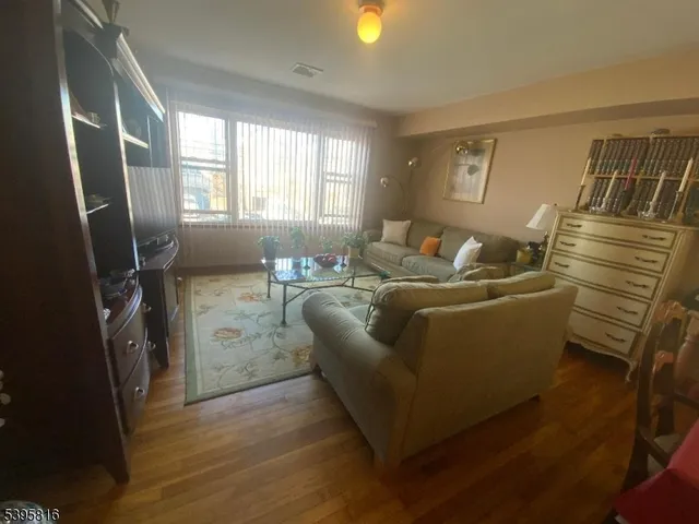 a kitchen with a sink a stove top oven a refrigerator and cabinets