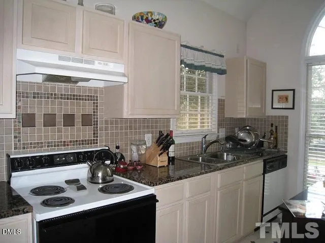 a kitchen with a sink cabinets and appliances