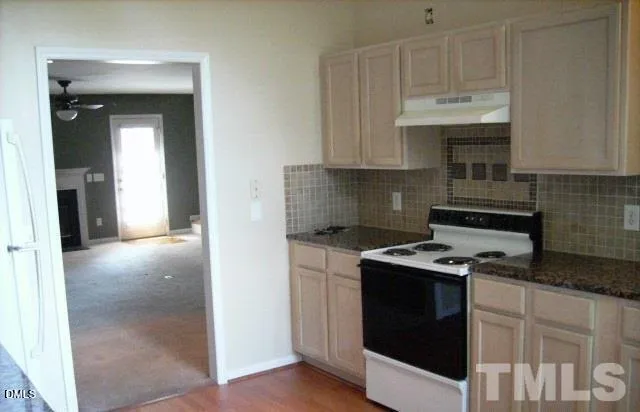 a kitchen with stainless steel appliances granite countertop a stove and a refrigerator