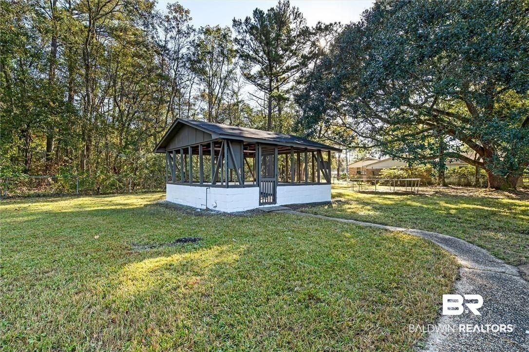 3005 Club House Road Mobile, AL 36605 - Photo 19 of 20 Exterior space with a lawn and a sunroom