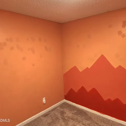 a view of an empty room and a window