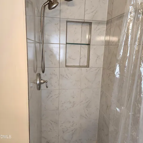 a bathroom with a glass shower door