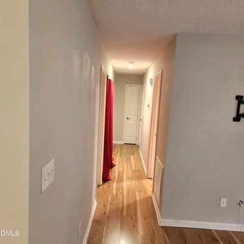 a view of hallway with wooden floor