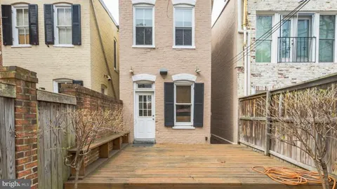 a view of a brick house with many windows