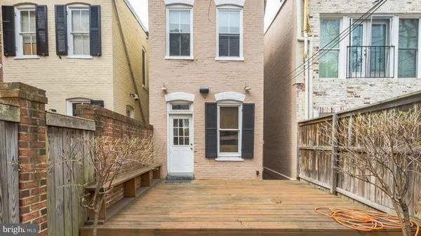 a view of a brick house with many windows