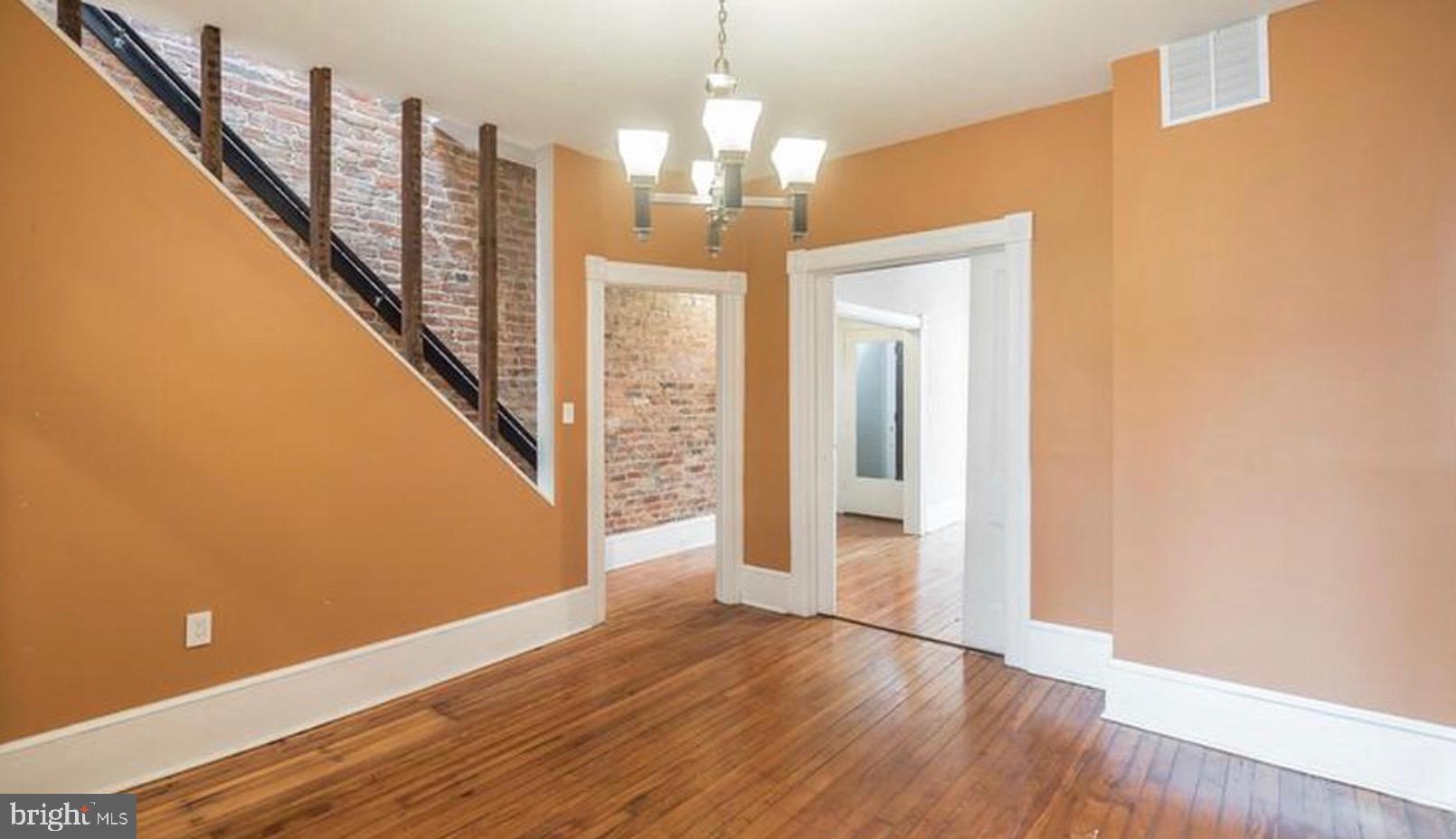 1319 35th Street Northwest Washington, DC 20007 - Photo 8 of 20 a view of a hallway with wooden floor and staircase