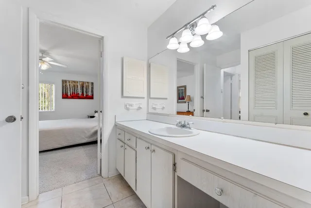 a en suite bathroom with a double vanity sink and a mirror